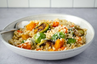Warm and comforting winter or fall vegetable pot of pearl couscous with brussel sprouts and squash. Easy, healthy, filling, plant-based, vegan recipe