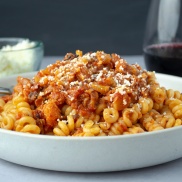 A bowl of cauliflower bolognese meat-free sauce over a bowl of pasta. Heart and filling vegan dinner recipe