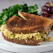 Curry chicken alternative chickpea salad sandwich on toast made form chick peas, mayo, curry powder, and golden raisins. Easy, healthy, filling, plant-based, dairy-free, vegan recipe