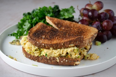 Curry chicken alternative chickpea salad sandwich on toast made form chick peas, mayo, curry powder, and golden raisins. Easy, healthy, filling, plant-based, dairy-free, vegan recipe