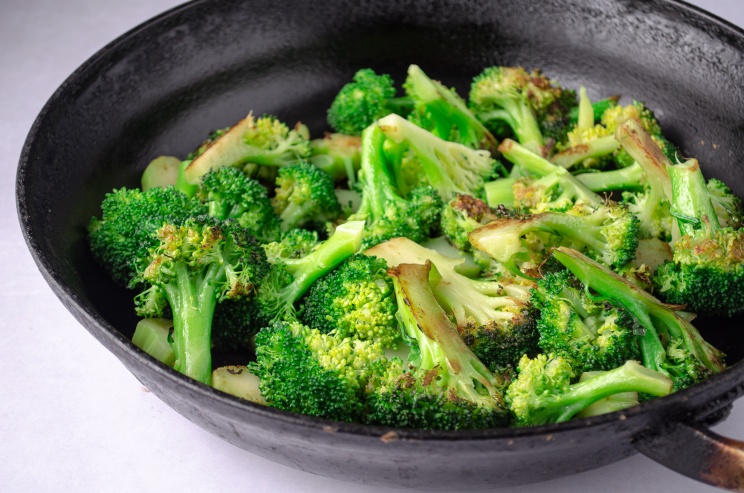 A pan of cooked broccoli using the steam saute technique
