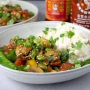 Easy weeknight dinner of everyday stir fry in a bowl made from snow peas, mushrooms, peppers, soy sauce, and white rice. Easy, healthy, filling, plant-based, dairy-free, vegan recipe