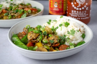 Easy weeknight dinner of everyday stir fry in a bowl made from snow peas, mushrooms, peppers, soy sauce, and white rice. Easy, healthy, filling, plant-based, dairy-free, vegan recipe