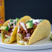 Tacos made meat-free from lentils and walnuts in crunchy corn tortilla shells and topped with radishes, avocado, red onion, cabbage, and lime.. Easy, healthy, filling, plant-based, dairy-free, vegan recipe
