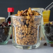 A jar of homemade Black Forest Granola with oats, almonds, chocolate chips, and dried cherries