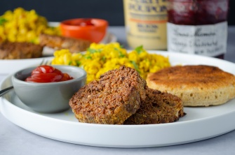 Meatless and plant-based (sausage-alternative) Breakfast Patties served with ketchup and tofu scrambled eggs