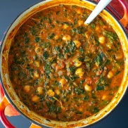 A pot of warm curry made from chickpeas, spinach, tomato