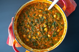 A pot of warm curry made from chickpeas, spinach, tomato