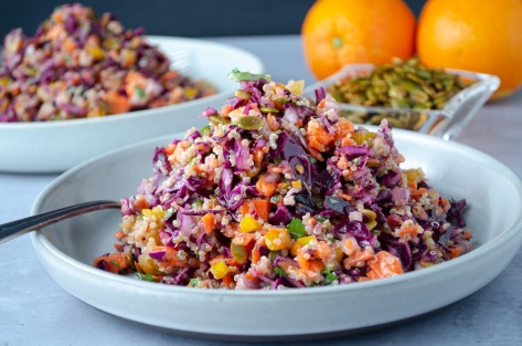 Cabbage salad blitzed in a food processor and topped with carrots, quinoa, dried apricots, pepitas (pumpkin seeds), and cilantro. Easy, healthy, filling, plant-based, vegan recipe