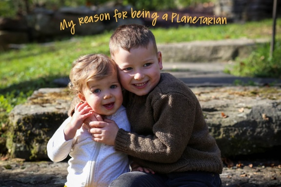 My reason for being a planetarian Two young children, a boy and girl, hugging, smiling, and sitting on stone steps