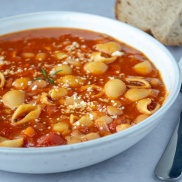 A bowl of pasta fagioli with pasta shells in a vegan, tomato based sauce