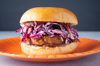 Vegan plant-based protein-packed barbeque bean burger topped with cabbage coleslaw