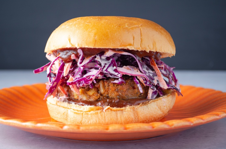 Vegan plant-based protein-packed barbeque bean burger topped with cabbage coleslaw