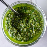 A jar of homemade vegan pesto made with a mixture of basil and kale