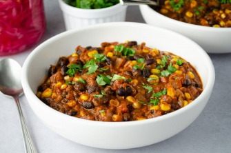A bowl of quick and easy vegan plant-based chili with black beans and corn