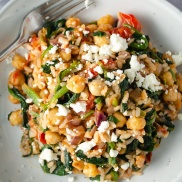 Vegetarian greek-flavored rice dish with tomato, spinach, chickpeas, and feta