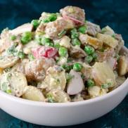 Creamy vegan potato salad with spring peas and radishes