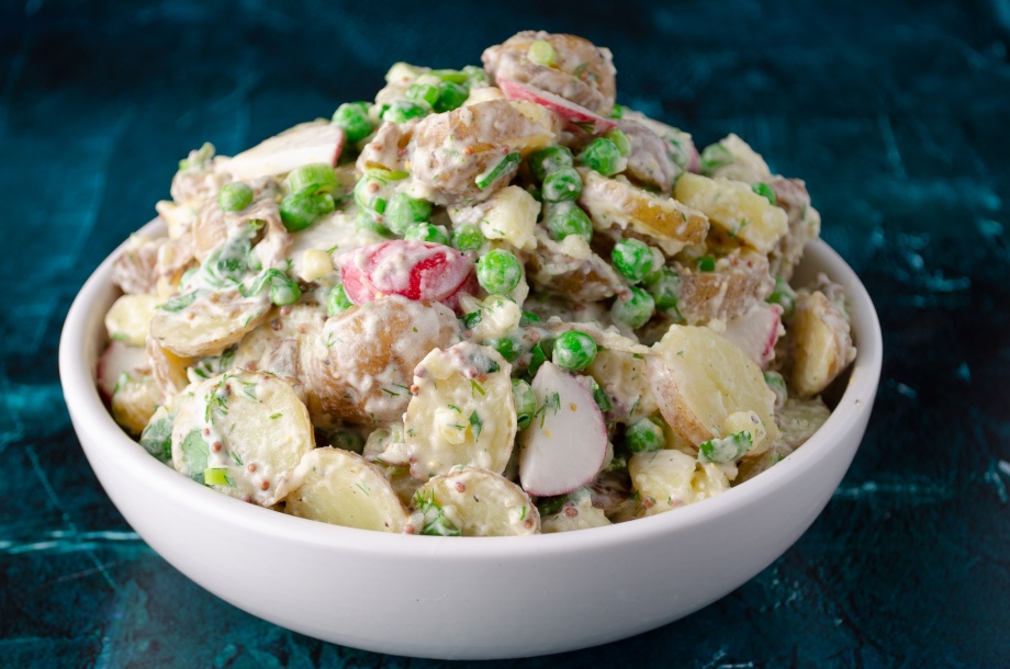 Creamy vegan potato salad with spring peas and radishes