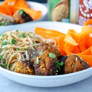 Southeast Asian flavored vegan, plant-rich tofu meatballs with noodles and shaved carrots