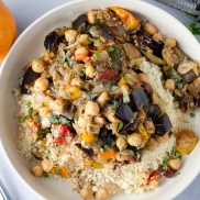 Roasted summer vegetable stew made from roasted zucchini, squash, and eggplant with chickpeas served over a bed of couscous