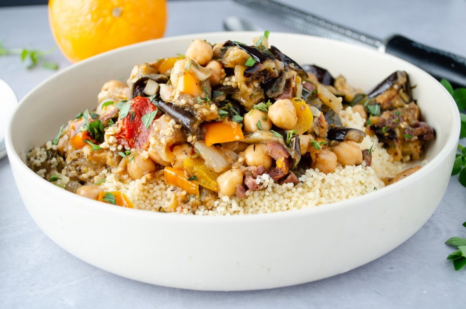 Roasted summer vegetable stew made from roasted zucchini, squash, and eggplant with chickpeas served over a bed of couscous