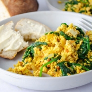 Vegan protein-full breakfast of tofu scrambled eggs with Spinach and Sundried tomato pesto