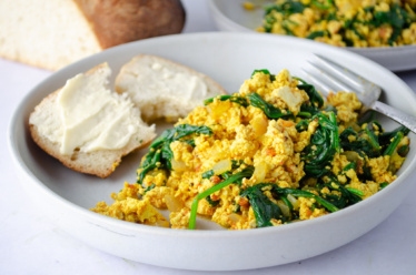 Vegan protein-full breakfast of tofu scrambled eggs with Spinach and Sundried tomato pesto
