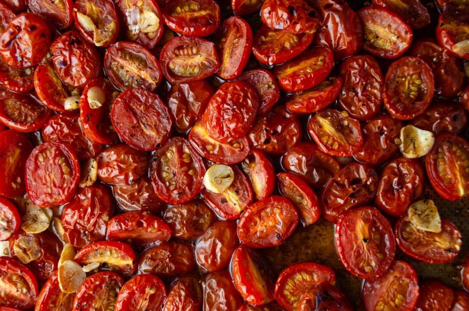 A tray of cherry tomato confit roasted with garlic until golden brown