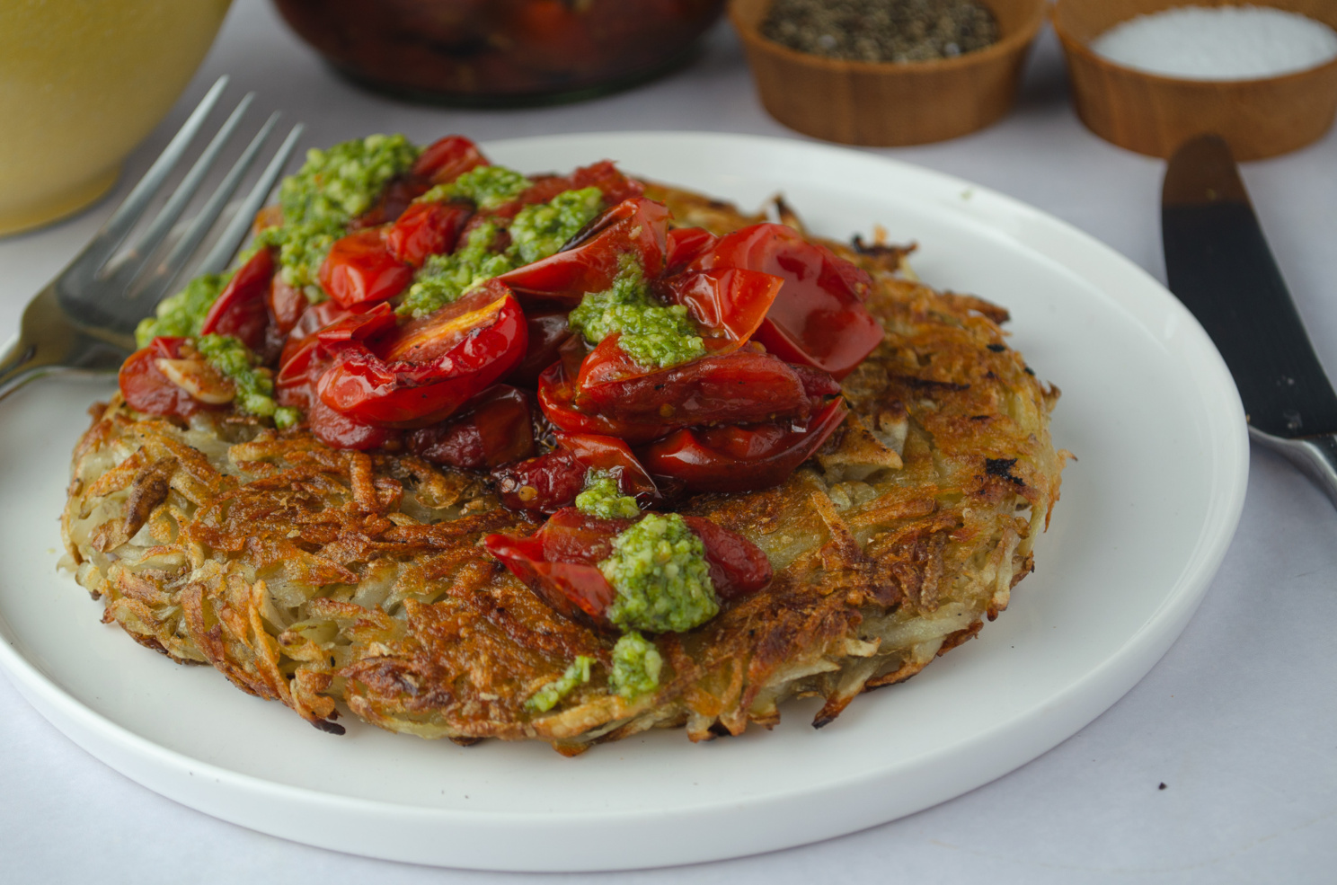 A quick and easy recipe for crisp and delicious potato rostis which can be a hearty vegan meal with the right toppings- here we used tomato confit and pesto