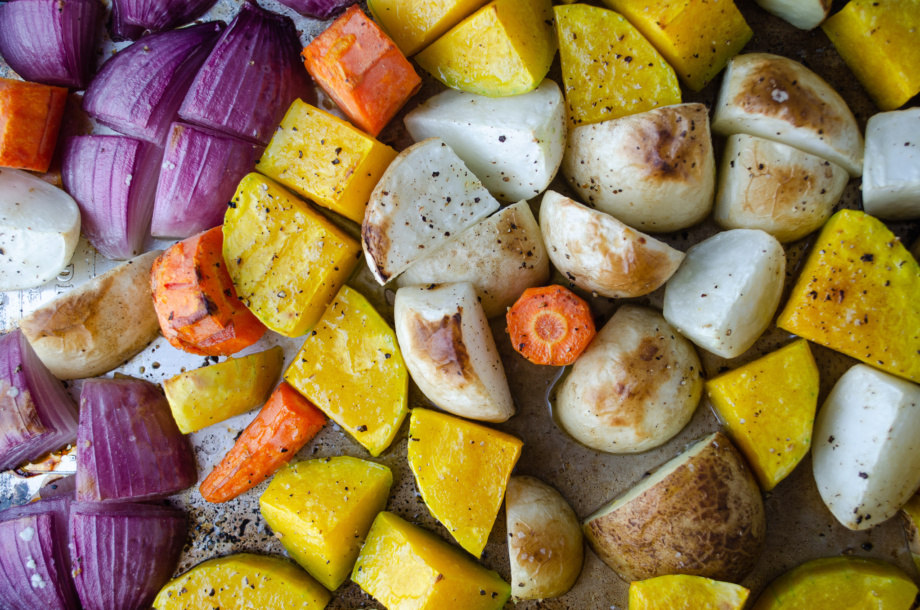 A tray of roasted winter vegetables - Carrots, turnips, rutabagas, golden beets, winter squash, parsnips, and onions