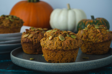 A plate of warm and cozy pumpkin spice muffins that are vegan, egg-free, and filling