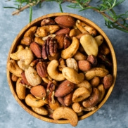 A bowl of delicious spiced nuts inspired by union square cafe's bar nuts with sweet, salt, tangy heat, and rosemary falvors