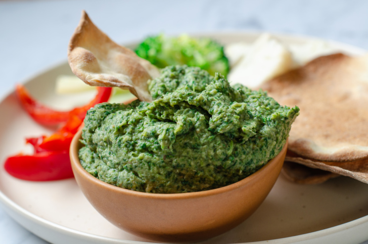 A bowl of our smoky, zesty kale-white bean dip, an integral part of our plant-rich, vegan festival holiday board