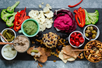 An impressive, colorful spread of plant-based vegan appetizers for a fall or winter holiday, celebration appetizer board