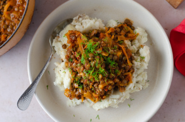 A warm, hearty, plant-based entree of lentil stew flavored with cabbage and caraway