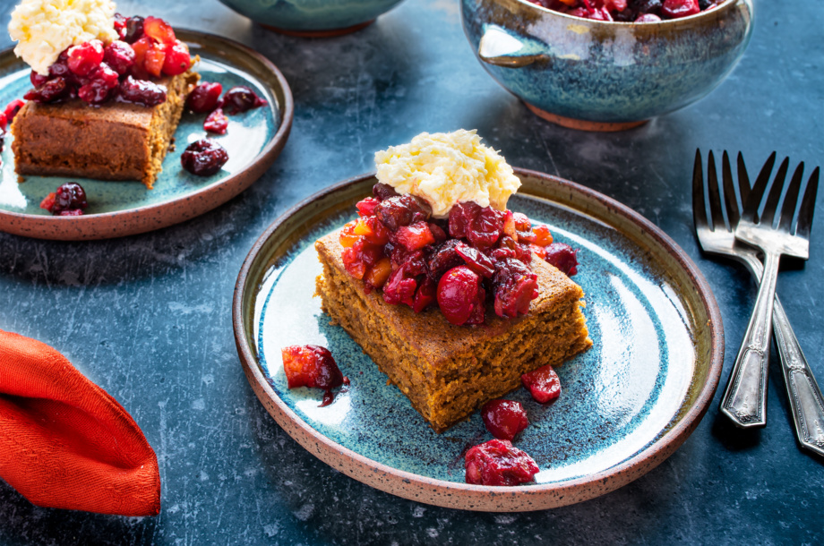 A festive vegan molasses spice cake with cranberry relish and whiskey hard sauce