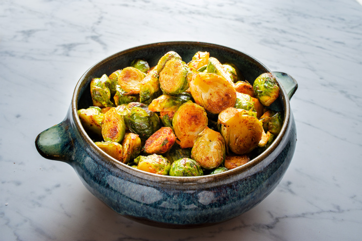 A tray of roasted brussels sprouts with smoked paprika, and a dash of lemon juice