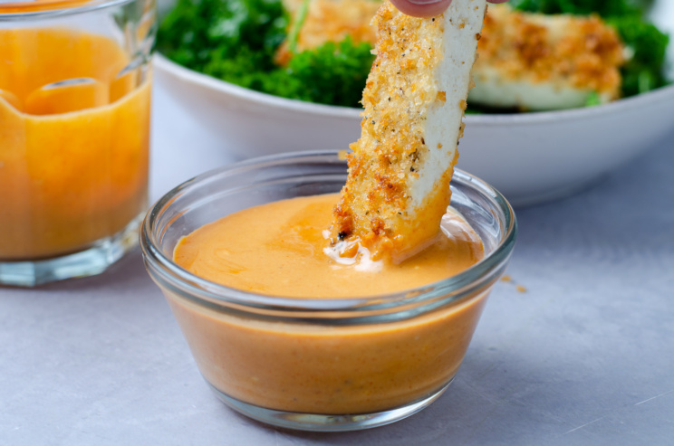 Crispy, satisfying plant-based panko-crusted planetarian "chicken" cutlets made from tofu dipped in buffalo sauce