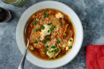 A bowl of kimchi and silken tofu soup that makes for a 10 minute, super-quick and easy vegan soup alternative for chicken noodle soup