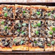 A tray of homemade, plant-based pizza flavored with roasted eggplant parm that can be completely dairy-free