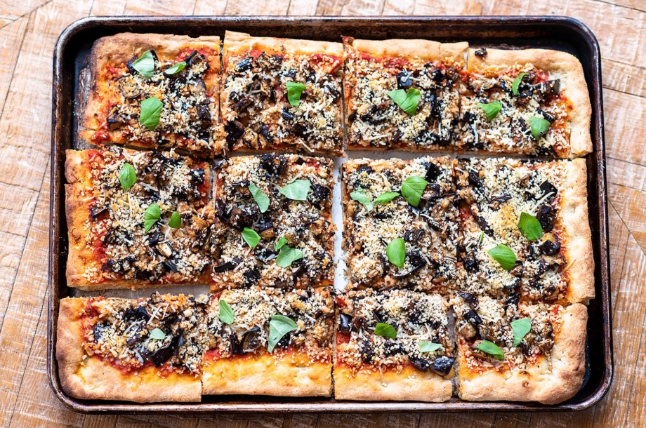 A tray of homemade, plant-based pizza flavored with roasted eggplant parm that can be completely dairy-free
