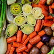 A try of perfectly roasted spring vegetables of asparagus, radishes, leeks, carrots, and baby potatoes