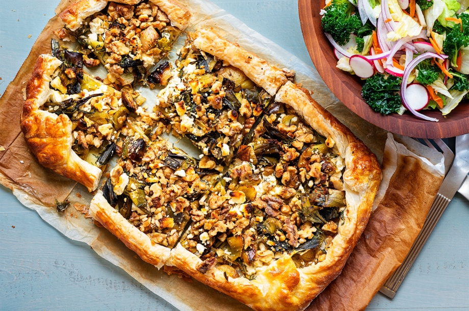 A golden, crisp puff pastry crust surrounds this roasted leek and potato galette made from roasted spring vegetables and topped with toasted walnuts and vegan, dairy-free feta cheese