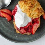 A plant-based whipped cream on top of beautiful bright strawberries, and a dairy-free biscuit makes the perfect strawberry shortcake