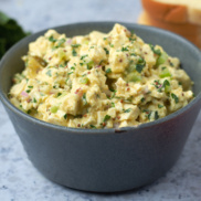 A bowl of vegan, plant-based "egg" salad made with all the classic flavors and ingredients but with silken tofu instead of egg