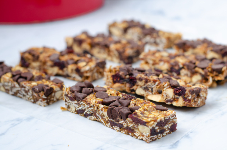 A tray of homemade, no-bake granola bars packed with plant-based, all-natural, energy-packed ingredients like oats, dates, nuts, and fruit 