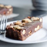 A white dish with a vegan, dairy-free, gluten-free, plant-based chocolate almond tart